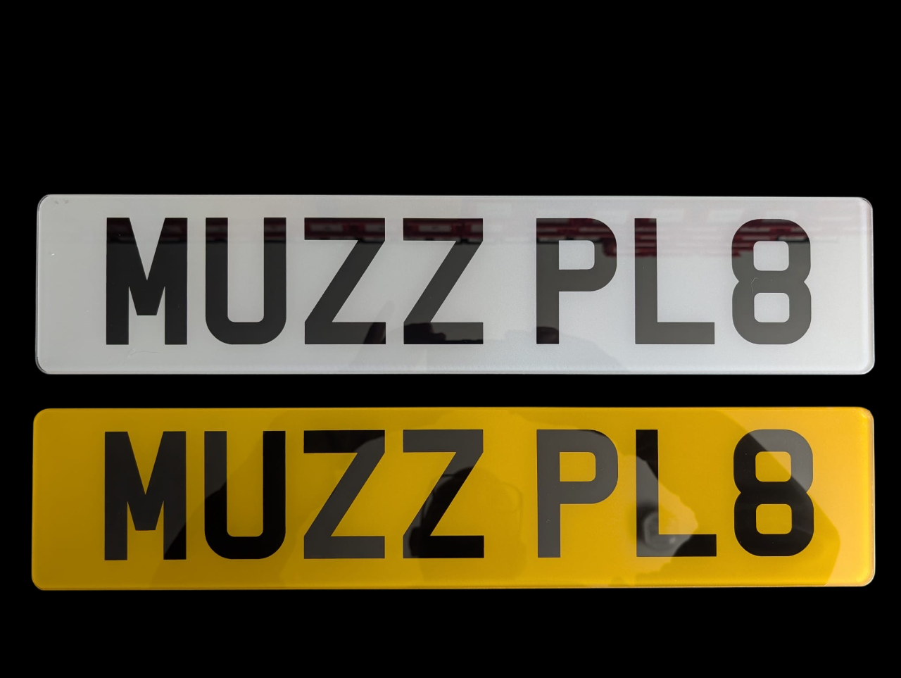 Two 2D number plates with 'MUZZPLATES' branding on a black background