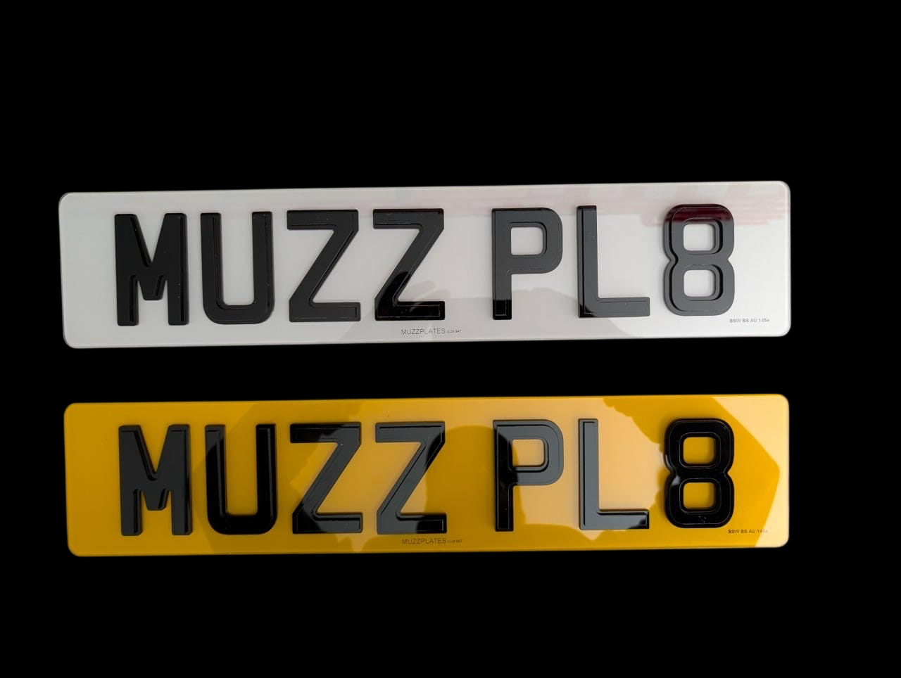 Two obsidian number plates with 'MUZZPLATES' branding on a black background